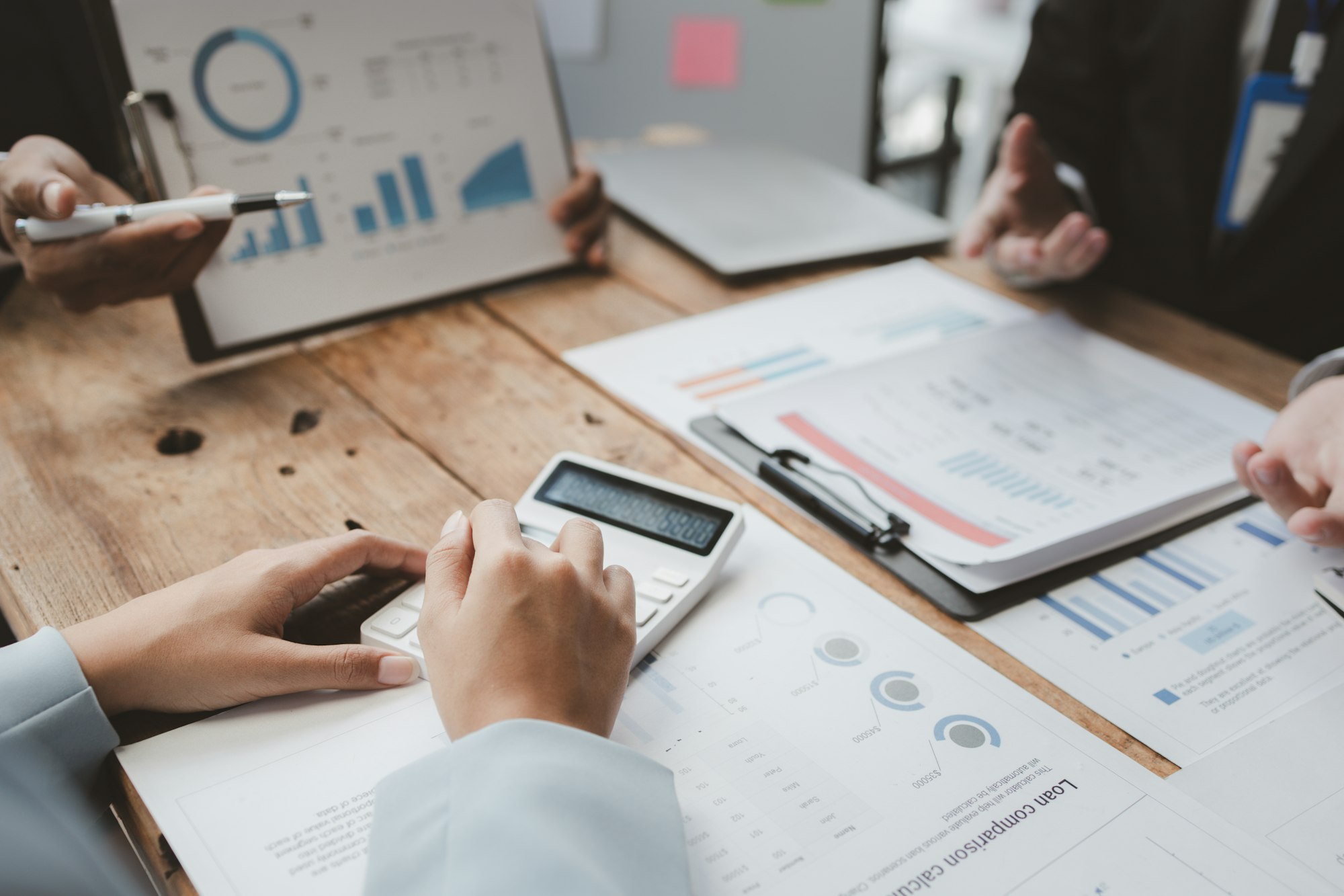 Team of analyst working on financial data analysis dashboard on paper as marketing indication for bu